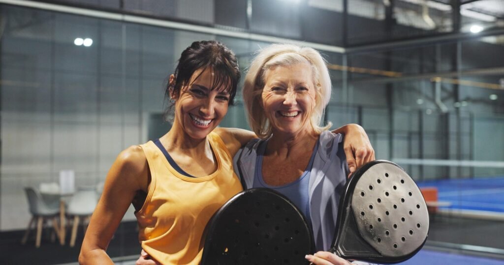 Mujeres adultas en una pista de pádel con una pala